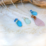 blue, green, and pink sea glass wire wrapped pendants handmade with chains