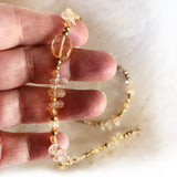 hand holding gold citrine natural tear drop gemstone short (17") necklace
