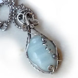 wire wrapped sterling silver pendant with pale teal blue amazonite