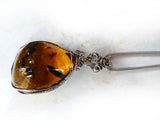 Side of Amber & sterling silver custom wire wrapped setting