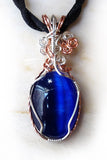 dark blue swirls cats eye wire wrapped pendant necklace