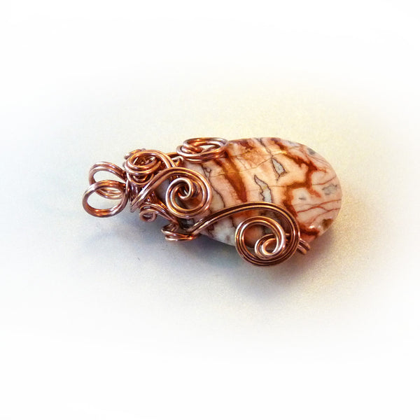 bright copper jewelry wire on pink, rust agate teardrop