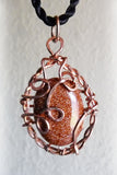 handmade copper pendant with shiny brown gemstone