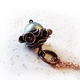 green swarovski pearl & copper acorn wire wrapped pendant