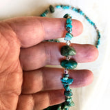 Closeup of blue green silver and genuine turquoise beads necklace with tree pendant