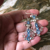 Hand holding Blue Sterling Silver Wire Wrapped Dangle Earrings - Handmade Swarovski Crystal Drop Earrings