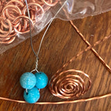 Artist crafting a Bird's Nest Pendant with Turquoise Eggs Handmade Copper Wire Wrapped