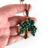 Hand holding Malachite Wire Wrapped Handmade Pendant, Copper