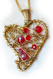 Tall image of wire wrapped heart pendant in red and gold.
