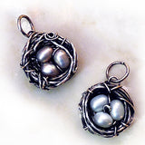 Handmade wire nest pendant with freshwater pearl eggs. 